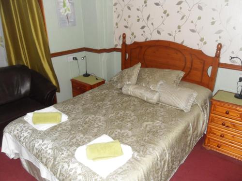 a bedroom with a bed with two towels on it at Bradleys Hotel in Blackpool