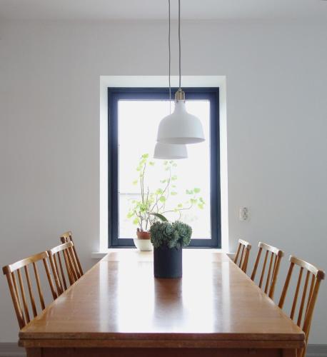 a dining room table with a potted plant on it at Vikens bed and Breakfast in Viken