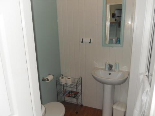 a bathroom with a sink and a toilet and a mirror at Bradleys Hotel in Blackpool