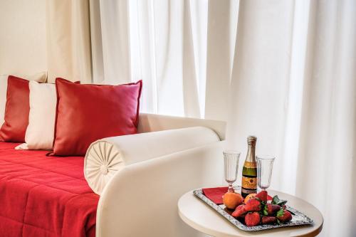 a table with a plate of fruit and a bottle of champagne at Auditorium Mecenate in Rome