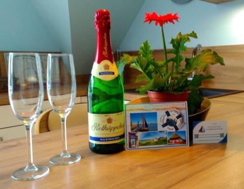 a bottle of champagne and two glasses on a table at Pier 605 - 4 Sterne - 300m Strand Zentrum - POWER WLAN - 2 Parkplätze - early CheckIn - #Bestpreisgarantie# in Zingst