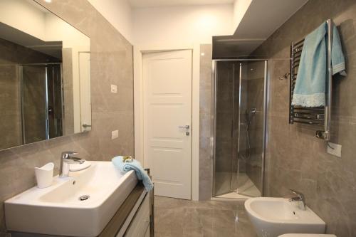 a bathroom with a sink and a shower at Casa Vacanze Residence Ideale Suites and Apartments in Alassio