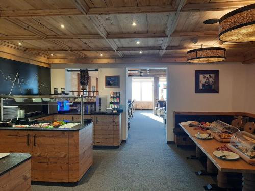 a large kitchen with wooden cabinets and a counter at Berggasthof Schatzbergalm in Thierbach