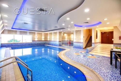 a pool in the lobby of a hotel at Elite Residence, Dubai Marina in Dubai