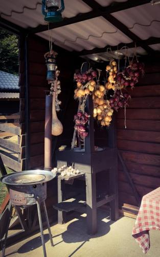 an outdoor kitchen with a stove and a table at Pansion Danica in Rastovača