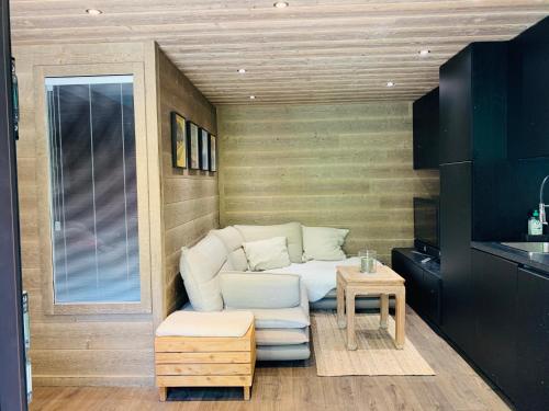 a small living room with a couch and a table at duplex en plein centre d'Auron déco chalet cosy in Saint-Étienne-de-Tinée