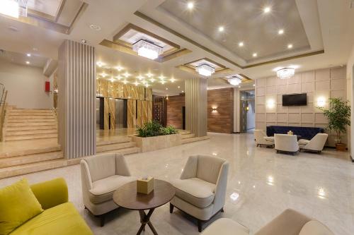a lobby with chairs and a table in a building at Jermuk Hotel and SPA in Jermuk