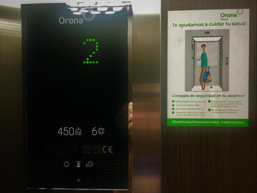 an elevator door with a sign on it with a woman inside at MD Design Hotel - Portal del Real in Valencia