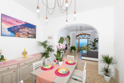 a kitchen and dining room with a table and chairs at Villa genny and emily in Positano
