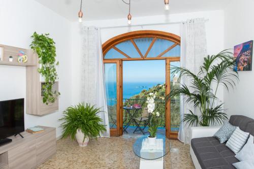 
a living room filled with furniture and a window at Villa genny and emily in Positano

