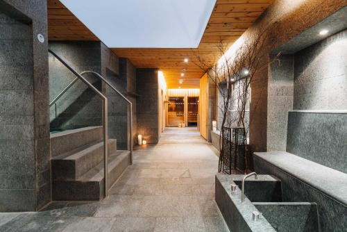 a hallway of a building with stairs and a lobby at Hotel Aurora in Lech am Arlberg