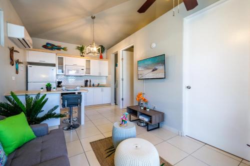 a living room with a couch and a kitchen at Villas at Aguada Sea Beach in Aguada