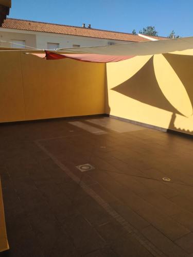 a patio with awning on the side of a building at Beautiful House Sierrecilla in Humilladero
