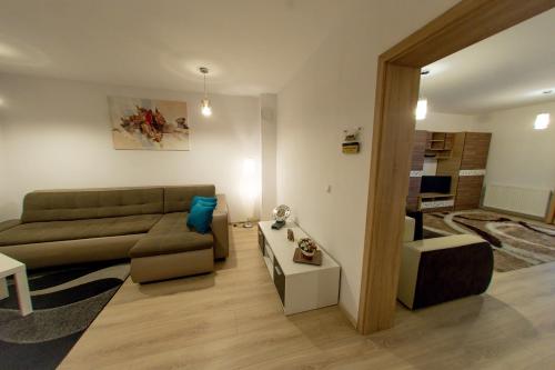 a living room with a couch and a table at Terezianum Apartments, Free Parking in Sibiu