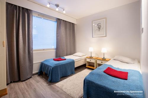 a room with two beds and a window at Rovaniemi City Apartments in Rovaniemi