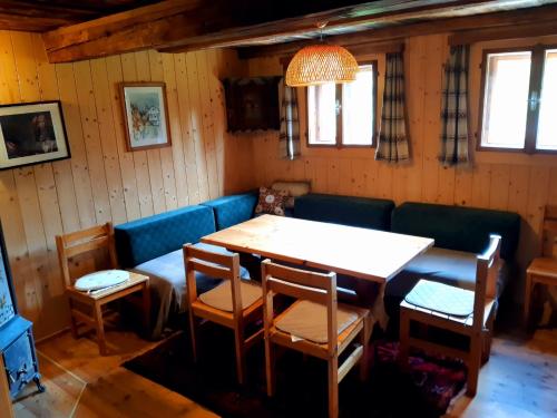 a dining room with a table and a couch at Chalet Verdino in Bad Kleinkirchheim