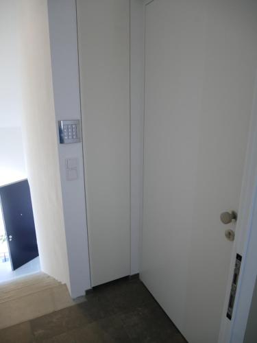 a hallway with white walls and a door at Penthouse 37th HEAVEN (ca. 90m²) in Lochau