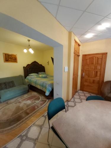 a living room with a bed and a couch at Atgiris in Palanga