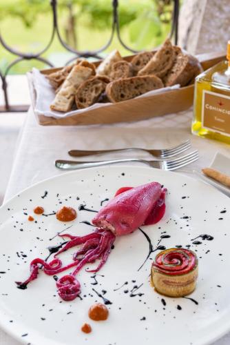 a plate of food on a table with a plate of bread at Villa Arcadio in Salò