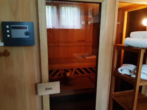 a room with a bathroom with a bed and a television at Chalet Verdino in Bad Kleinkirchheim