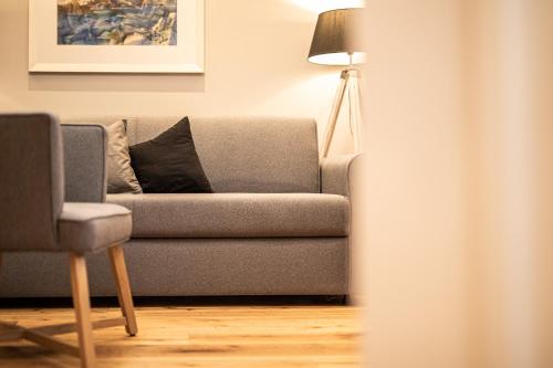 a living room with a couch and a lamp at Villa 10 in Oetz