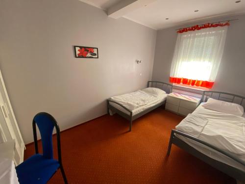 a small room with two beds and a window at Hotel Tequila in Międzyrzecz