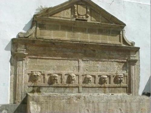 a stone building with statues on top of it at Hostal Breñaverde in Gaucín