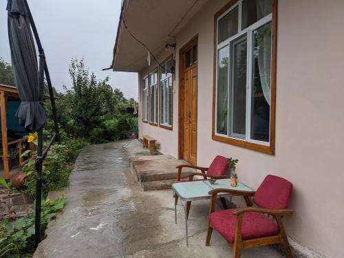a patio with a table and chairs and an umbrella at Tatev Guest House in Tatʼev