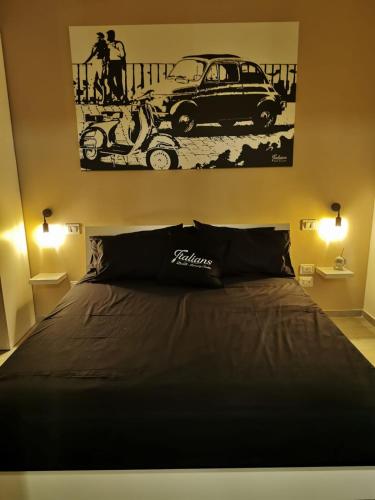 a bedroom with a bed and a picture of a car at Italians b&b luxury suite in Acquaviva delle Fonti