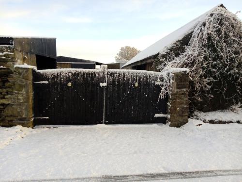 a fence that has some snow on it at Abbeyview House in Abbeyshrule