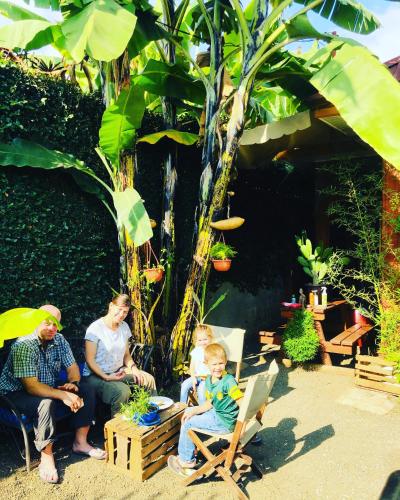 a group of people sitting in a garden at Savannah House in Arusha