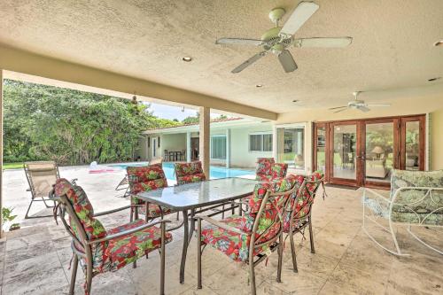 a patio with a table and chairs and a ceiling fan at 7545 Southwest 124th Street in Miami