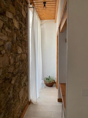 a hallway of a house with a stone wall at Casa da Igrejja in Almodôvar