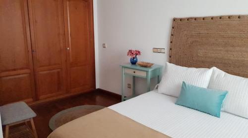 a bedroom with a bed with a blue pillow on it at Ramón y Cajal in Estepona