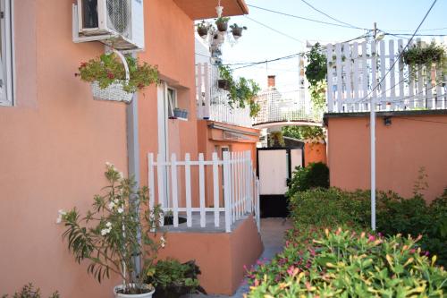 an alley between two buildings with a white fence at Apartment Sleep'n Drive in Belgrade
