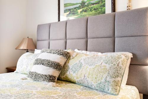 a bedroom with a bed with pillows and a headboard at Maui Vista in Kihei