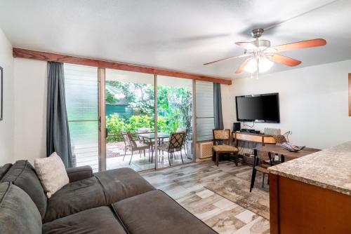 a living room with a couch and a tv and a table at Maui Vista in Kihei