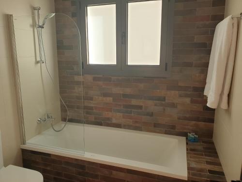 a bathroom with a bath tub with a window at Melissonas Villas in Phini