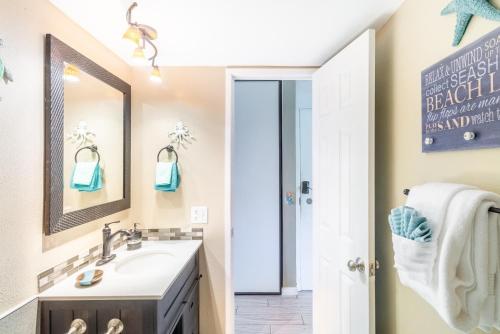 a bathroom with a sink and a mirror at Maui Vista in Kihei