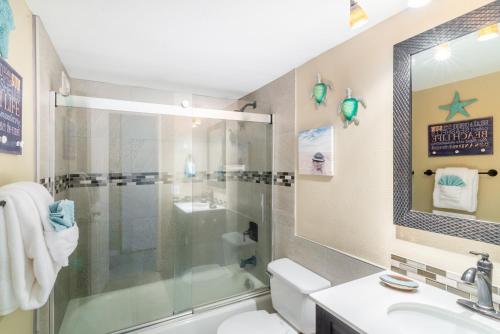 a bathroom with a shower and a toilet and a sink at Maui Vista in Kihei