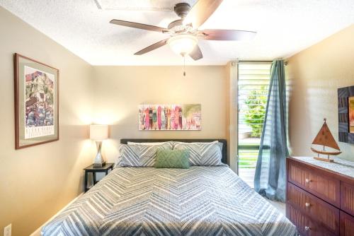 a bedroom with a bed and a ceiling fan at Maui Vista in Kihei