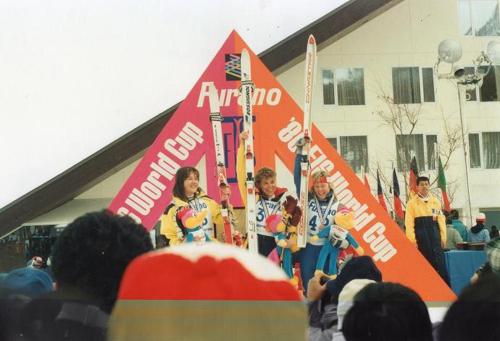 a group of people holding skis in front of a crowd at Minshuku Mutsukari in Furano