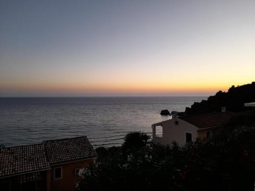 a view of the ocean at sunset from a house at Glyfada New Era Home 107 Menigos Resort Apartments in Glyfada