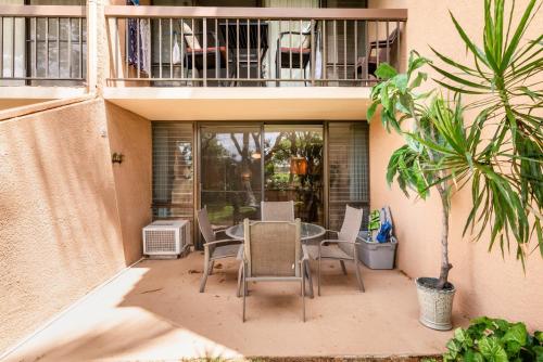 a patio with a table and chairs on a balcony at Maui Vista - Kihei Kai Nani Beach Condos in Kihei