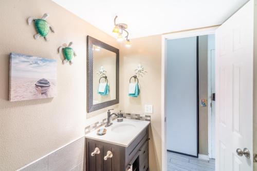 a bathroom with a sink and a mirror at Maui Vista - Kihei Kai Nani Beach Condos in Kihei
