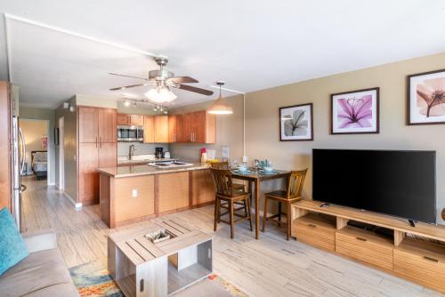 a living room with a flat screen tv and a kitchen at Amazing Kihei Kai Nani - Maui Vista One Bedroom Condos in Kihei
