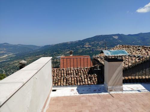 a view of a building with mountains in the background at Locazione Turistica Arcobaleno "Family Loft" in Roccavivara