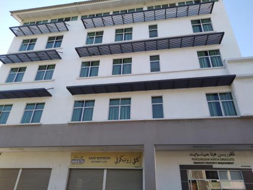 a white building with a lot of windows at Ginasuite Hotel in Bandar Seri Begawan