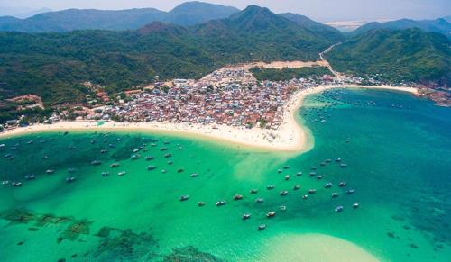 an aerial view of a beach with boats in the water at Luu Ngai Condotel Quy Nhon in Quy Nhon