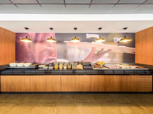 a buffet line in a restaurant with food at ibis Sao Paulo Ibirapuera in Sao Paulo